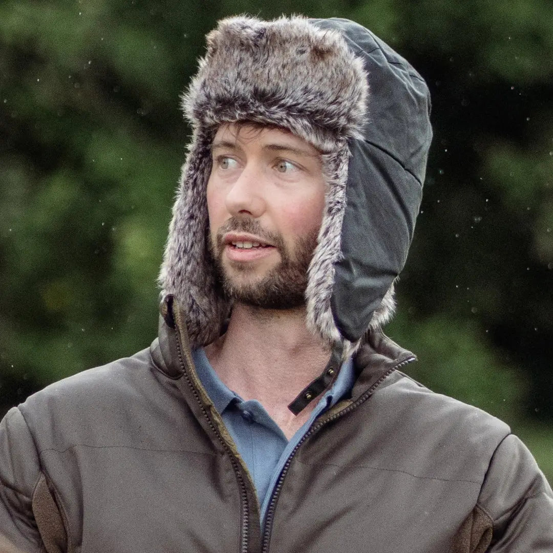 Bearded man rocking a cozy Forest Wax Trapper Hat with ear flaps for winter warmth