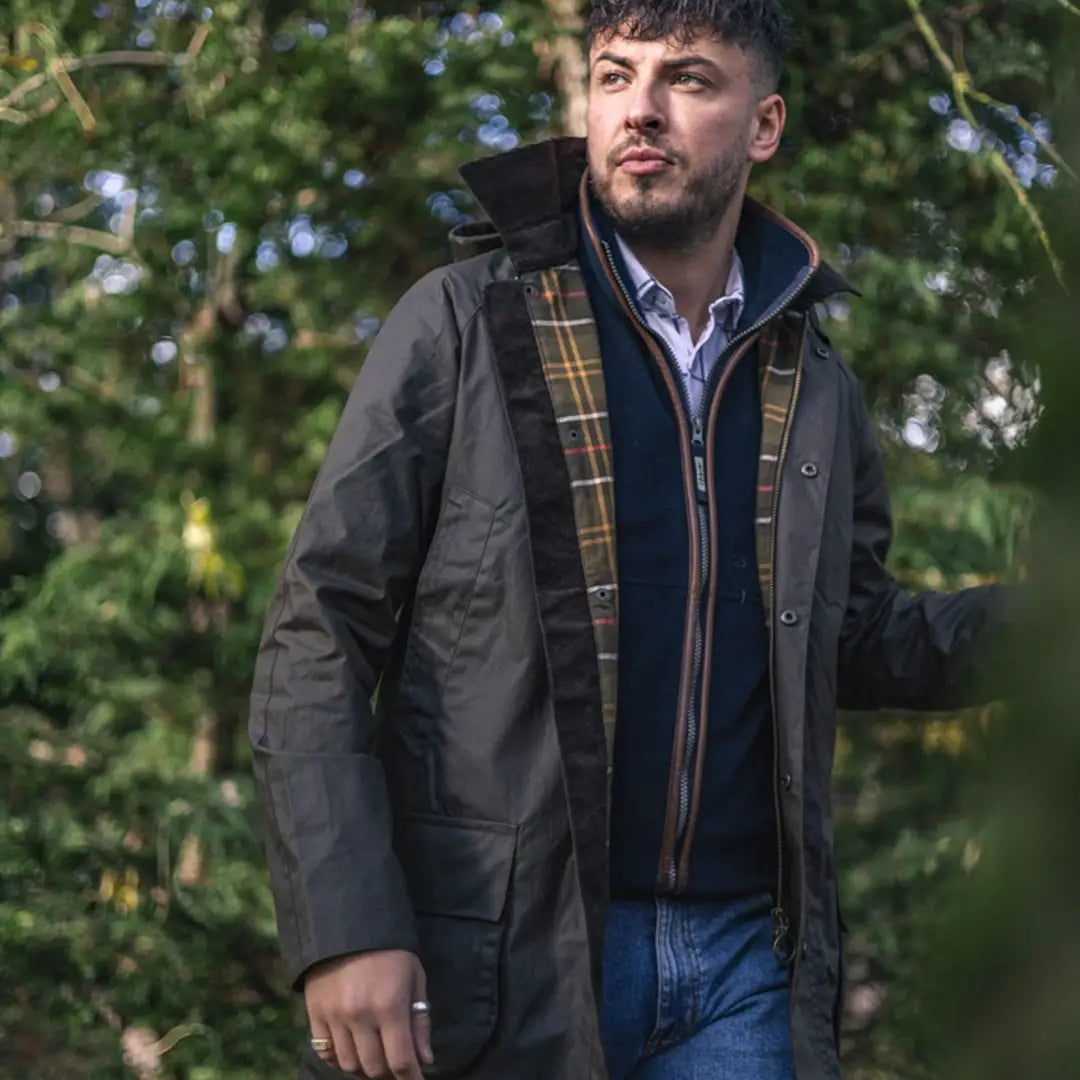 Man rocking the New Forest Woodsman Wax Jacket with plaid lining over casual wear