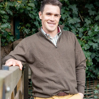 Man smiling in a brown zip neck jumper from New Forest, perfect for casual style