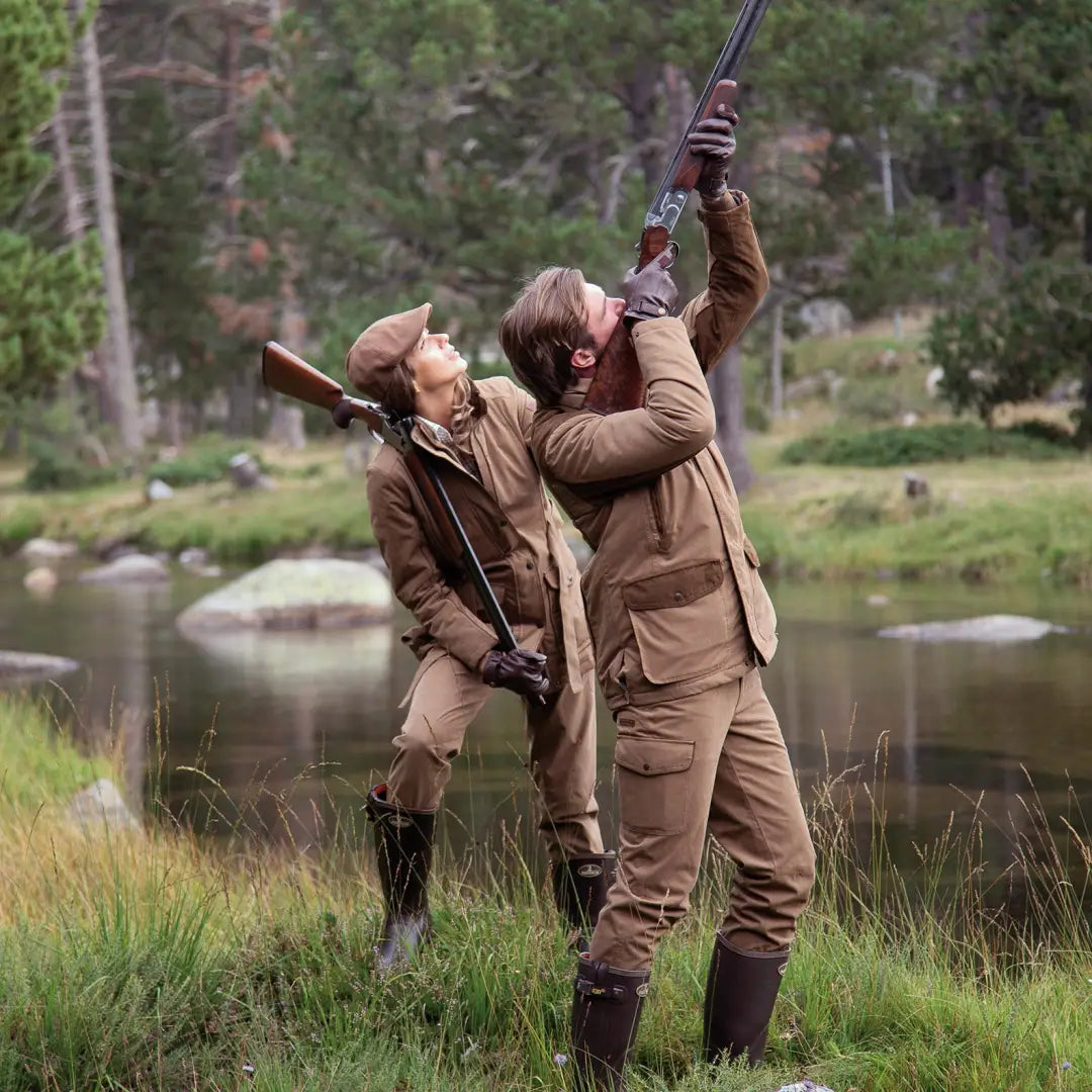 Two hunters aiming rifles in grass wearing Percussion Ladies Rambouillet Hunting Jacket