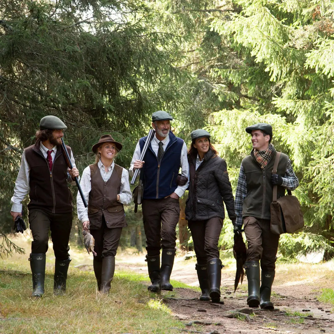 Group in vintage countryside outfits strolling a path wearing Percussion Scotland Fleece Vest