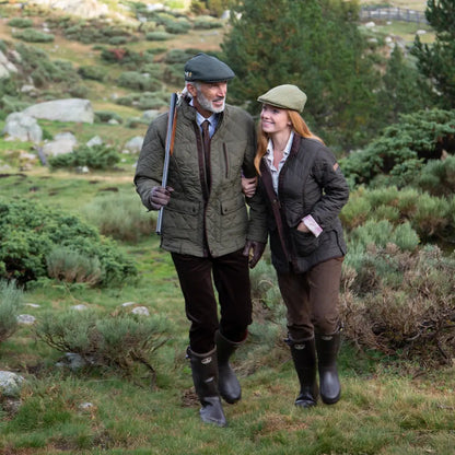 Couple in country clothing wearing Percussion Stallion quilted jacket outdoors