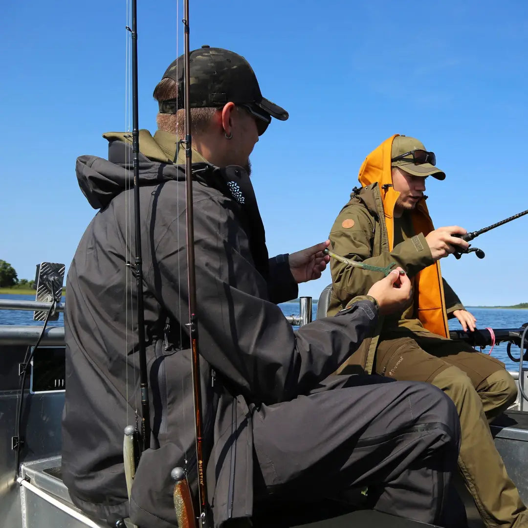 Two people fishing from a boat wearing the Pinewood Abisko Telluz Jacket anthracite