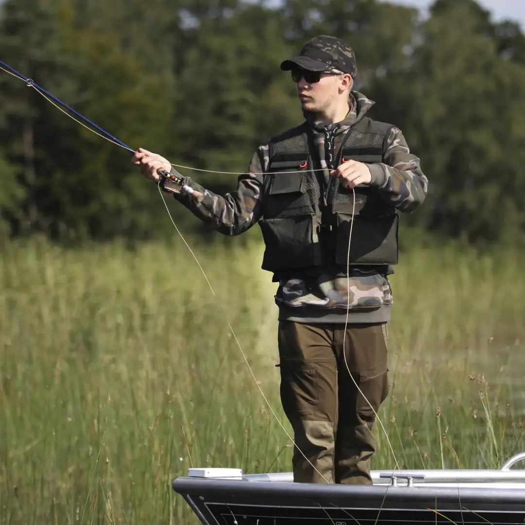 Fisherman in a boat casting with a breathable fishing vest for maximum comfort