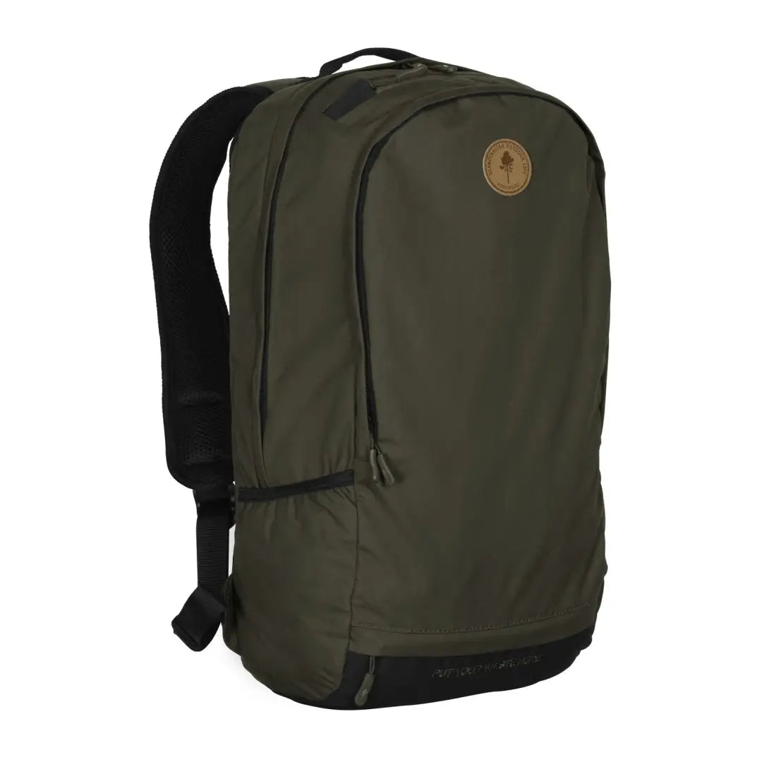 Dark green Pinewood Day Pack 22L with black straps and a circular logo patch