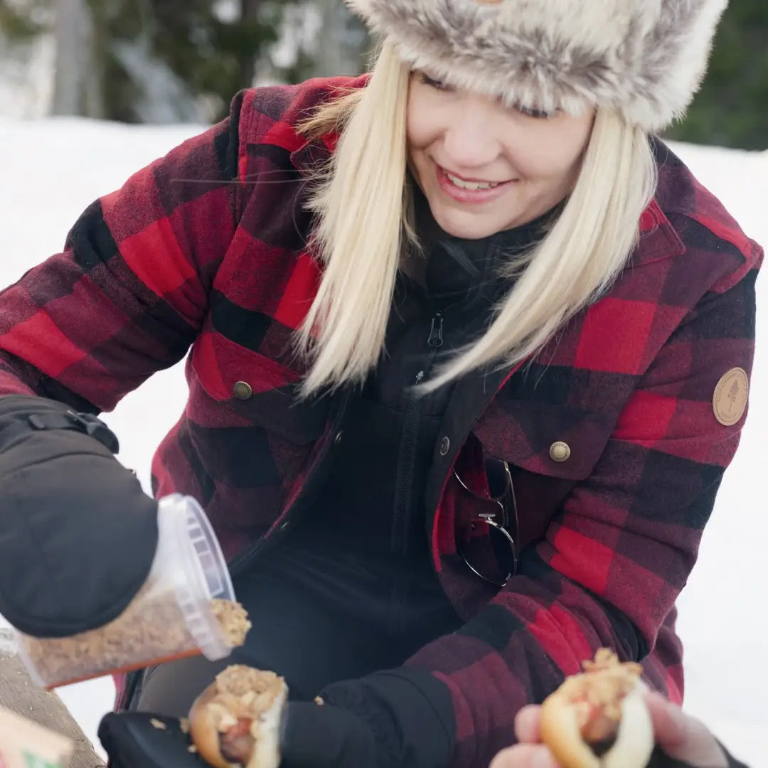 Person in a red and black plaid jacket pouring a drink outdoors in Pinewood Ladies Canada style