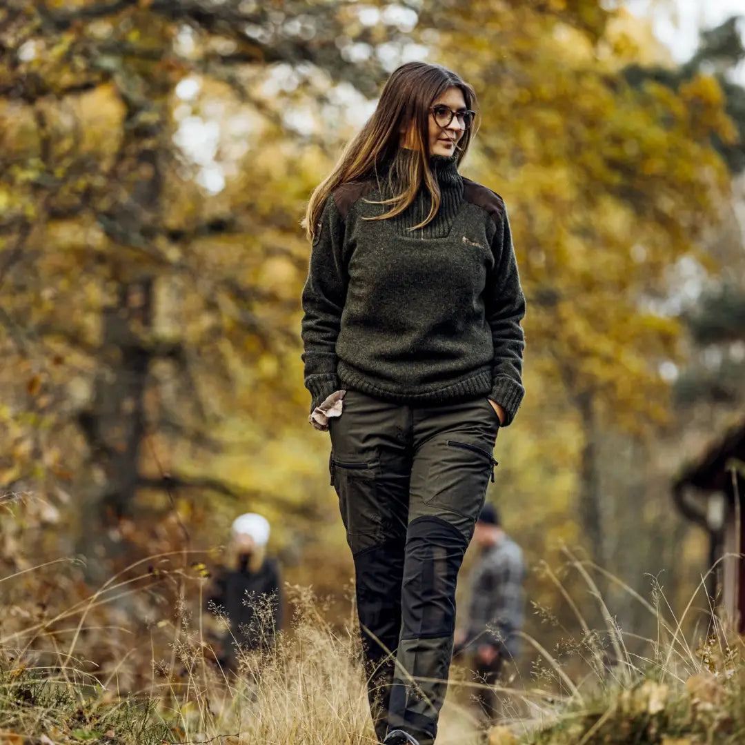 Woman in dark clothes walking in autumn wearing Pinewood Ladies Hurricane Sweater