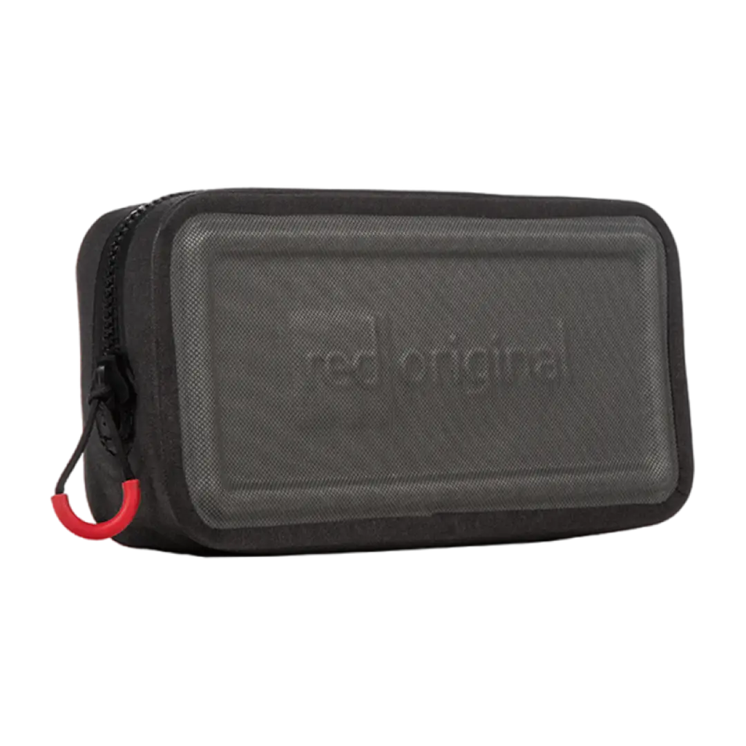 Portable speaker in a dark gray body with red accents beside a waterproof dry pouch