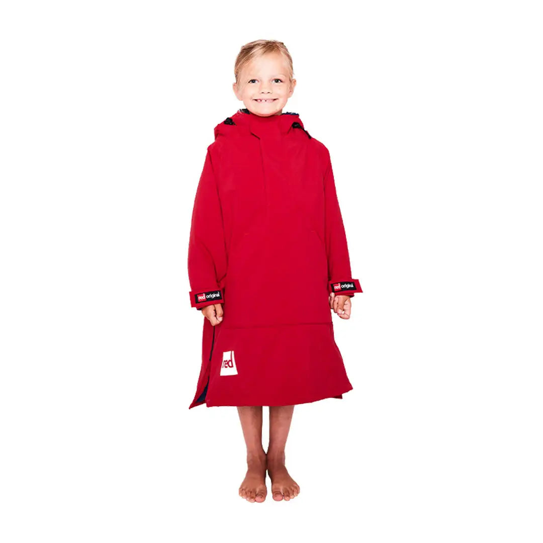 Red Kids Dry Poncho worn by a young child in a cozy hooded towel robe