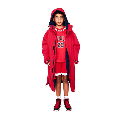 Child rocking a bright red oversized coat and Chicago Bulls uniform in a Kids Pro Robe