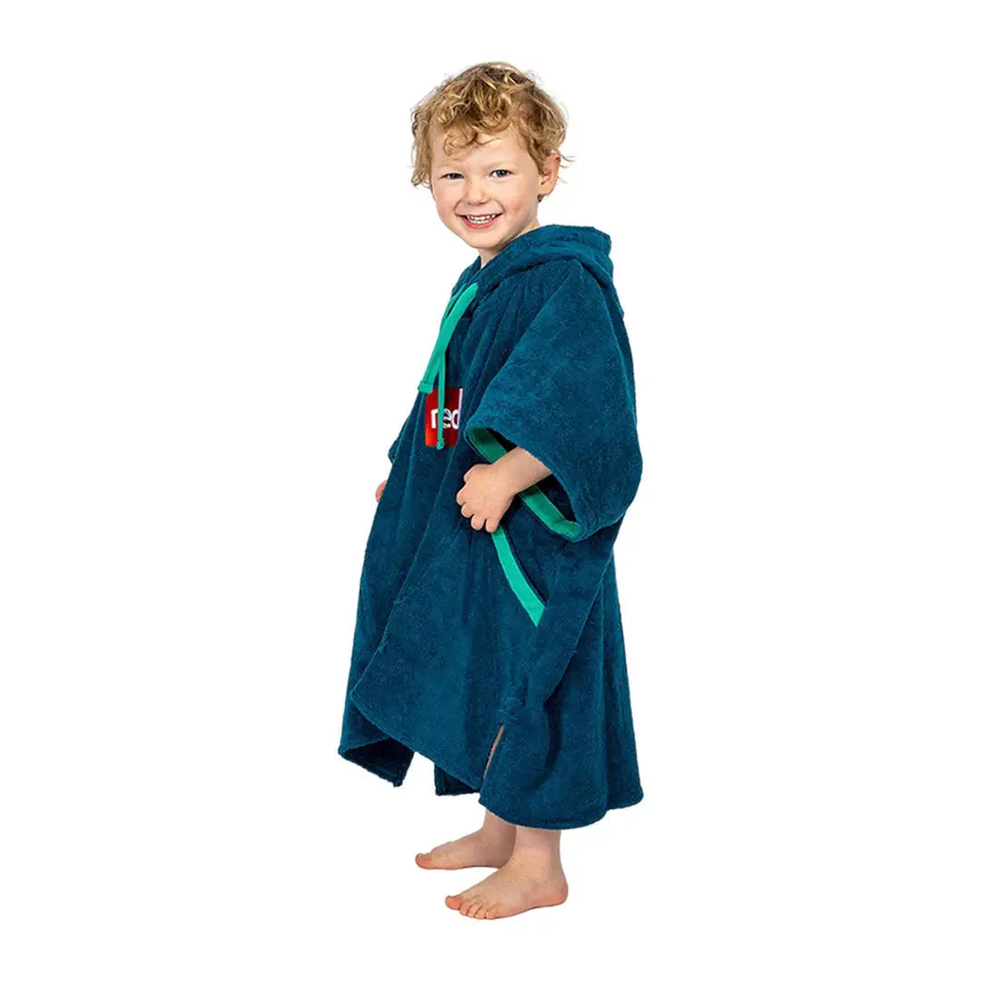 Child in blue hooded towel robe with red and green accents from Red Kids Luxury Towelling