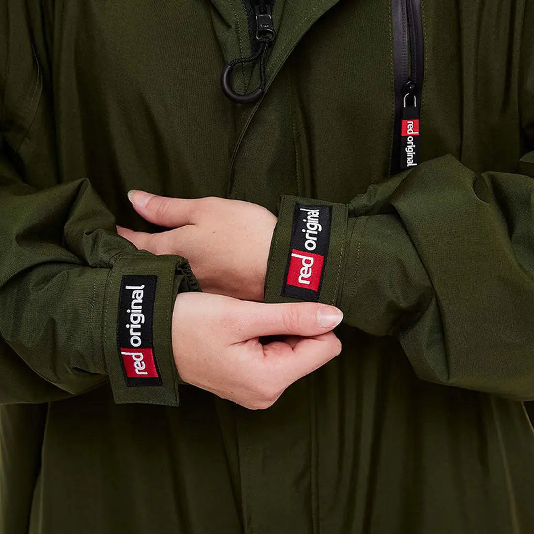 Hands in dark wristbands with red logos, showcasing the Red Pro Change Long Sleeve Evo Jacket