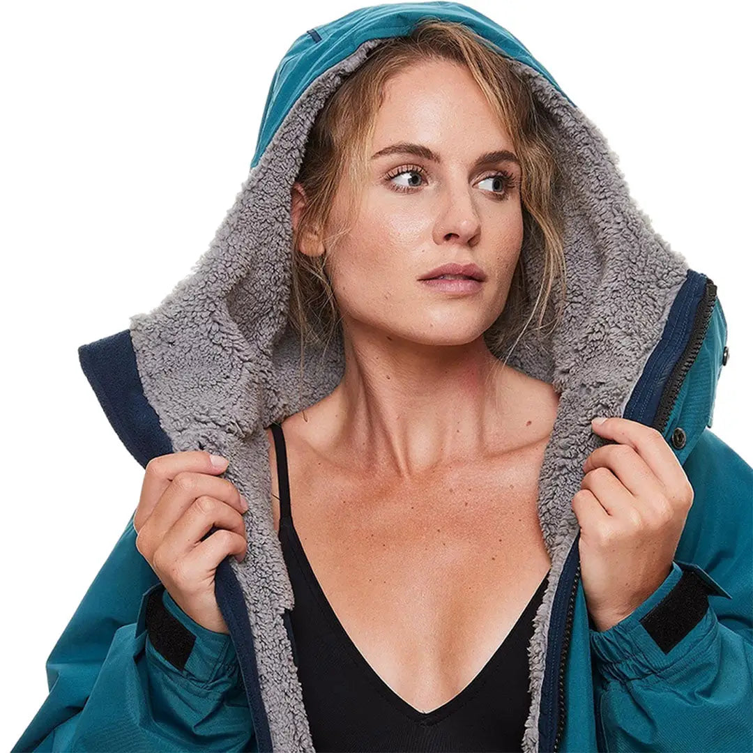 Woman in a teal hooded jacket with fleece, perfect for outdoor professionals and changing robes