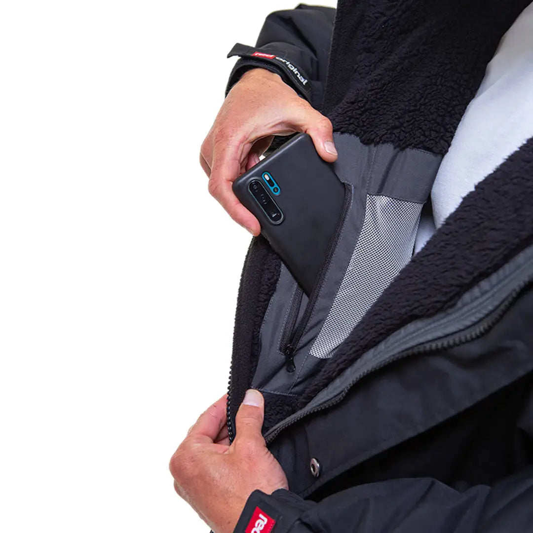 Smartphone sliding into the inner pocket of a Red Pro Change Long Sleeve Evo Jacket