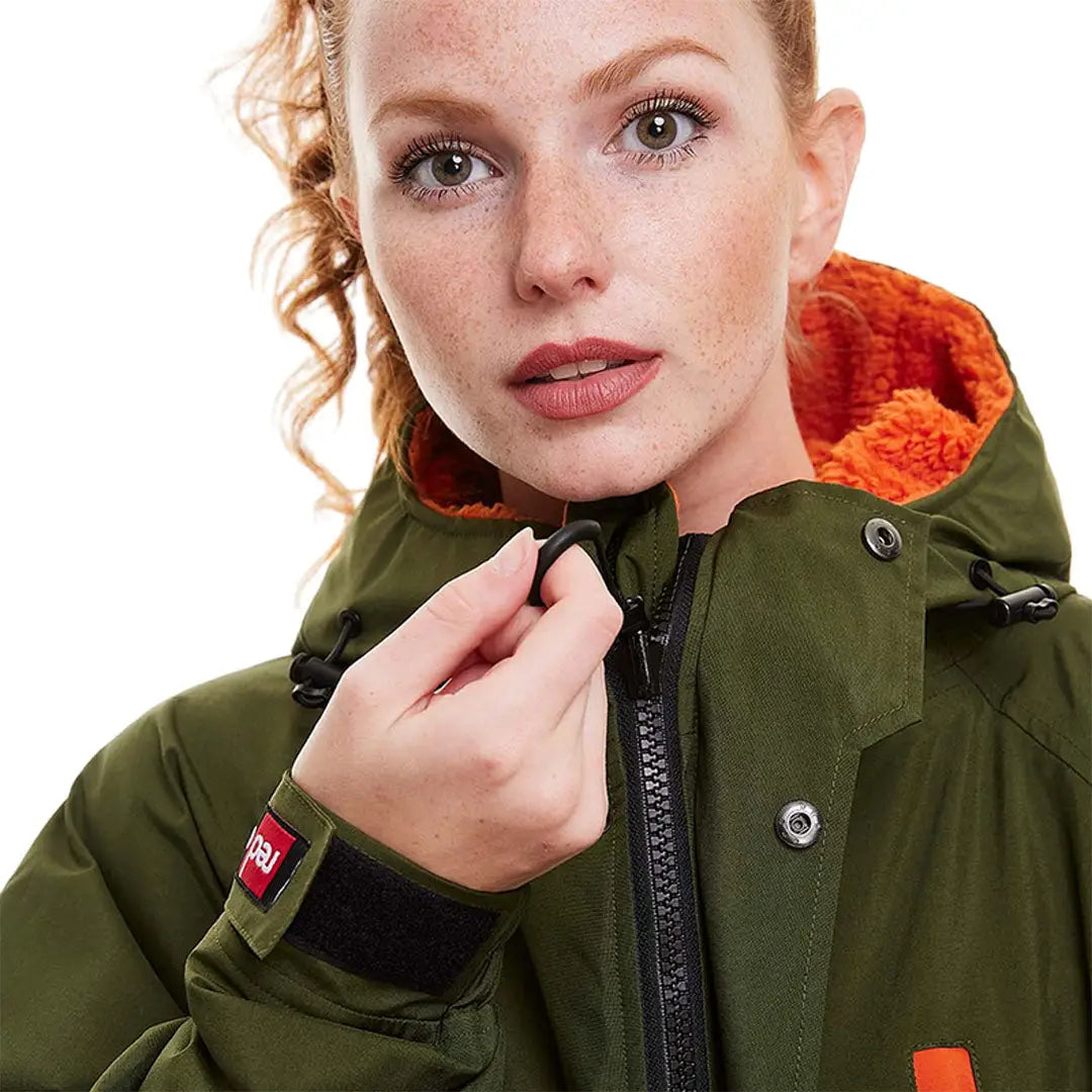 Green winter jacket with orange lining and hood, perfect for your change robe needs