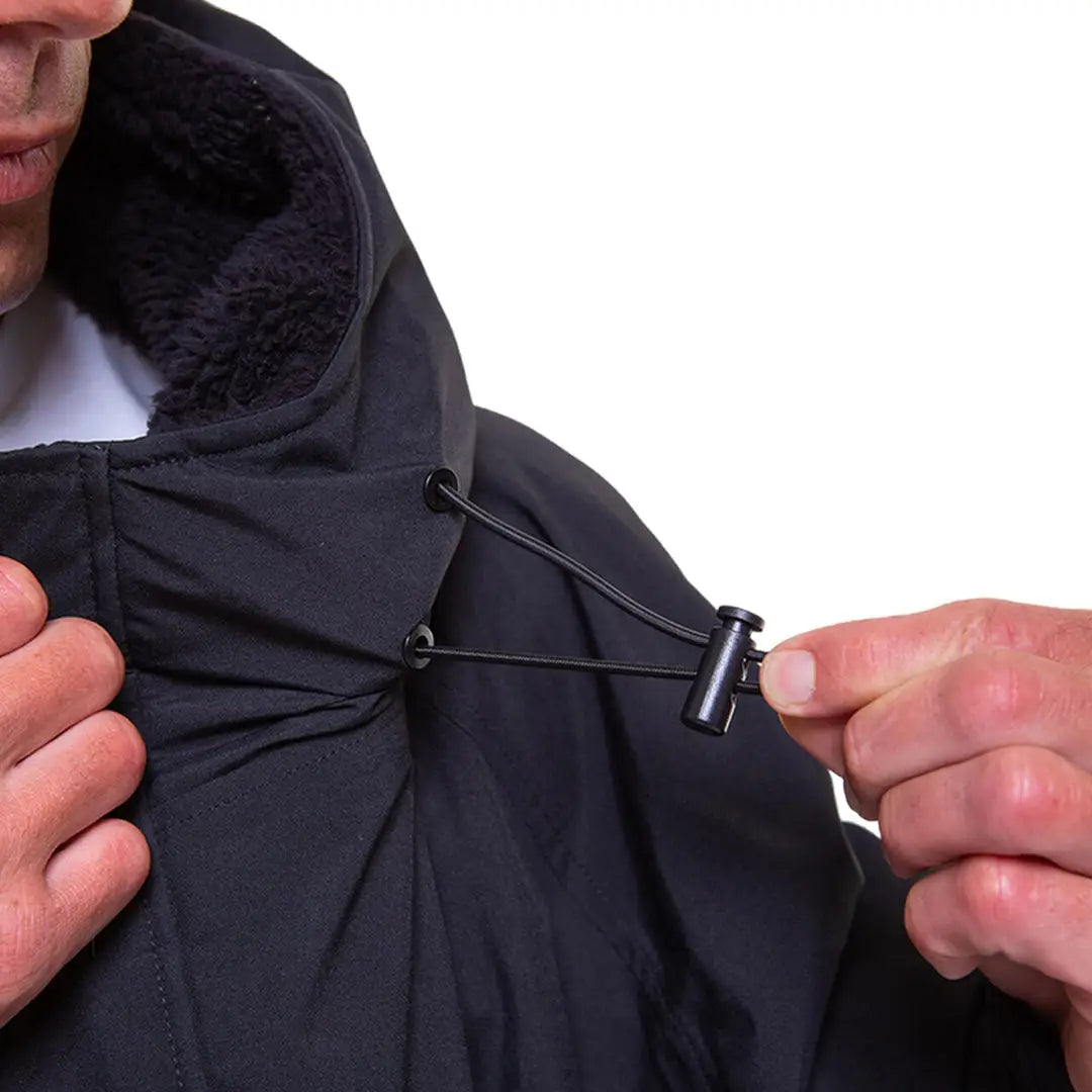 Hands adjusting the drawstring of a Black hooded jacket from the Red Pro Change Evo collection