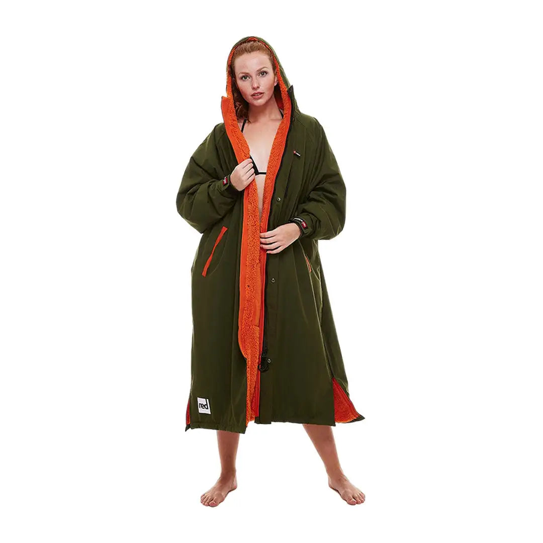 Woman in olive green robe with orange lining, featuring the Red Pro Change Long Sleeve Evo Jacket