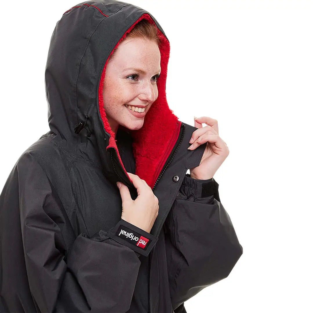 Black winter coat with red inner lining and hood from the Red Pro Change Long Sleeve Evo Jacket