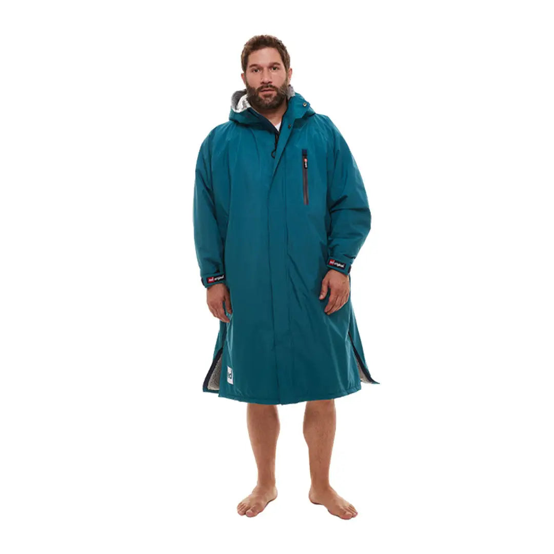 Bearded man in teal changing robe, showcasing Red Pro Change Long Sleeve Evo Jacket