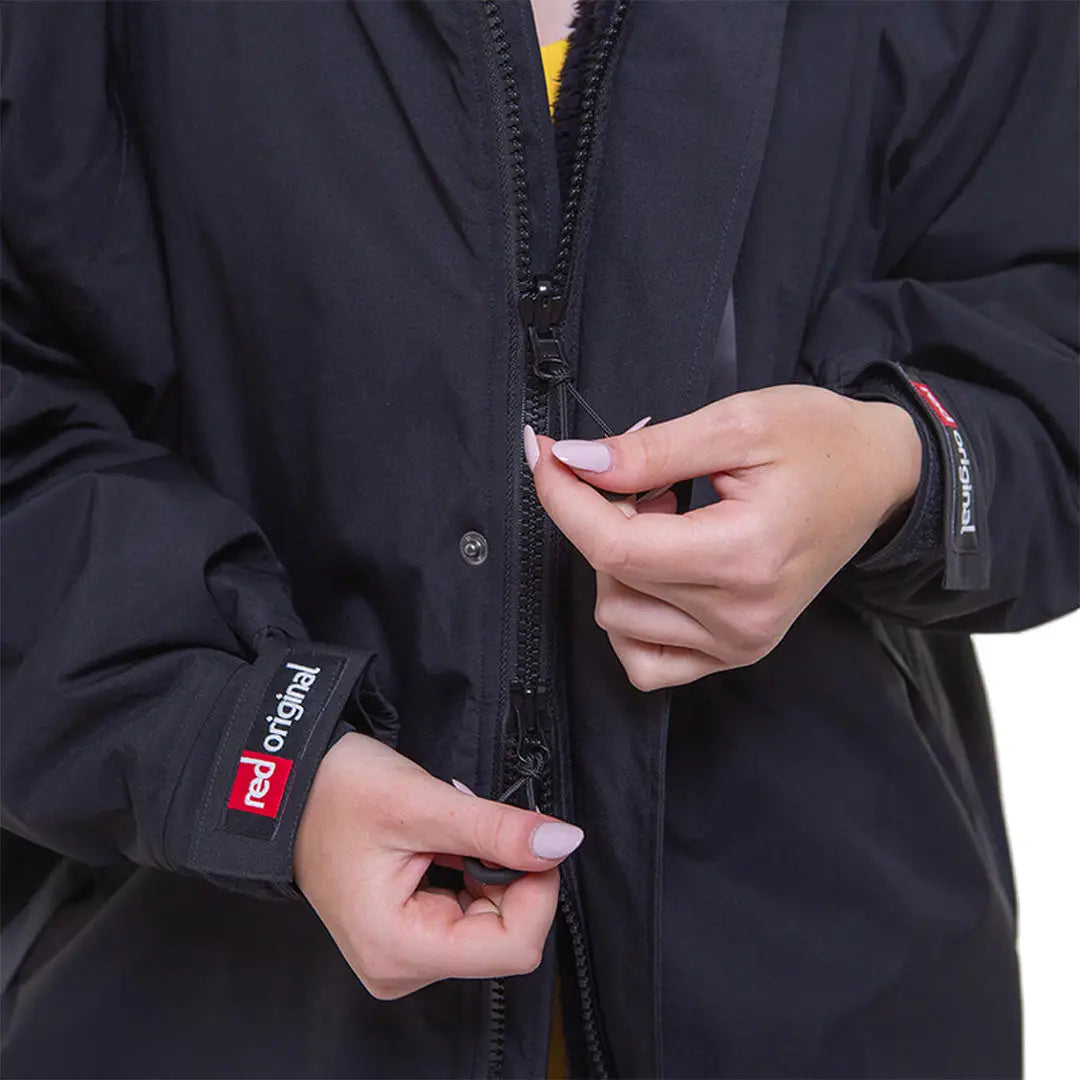 Black zippered jacket with Red Paddle Co branding, perfect change robe for active lifestyles