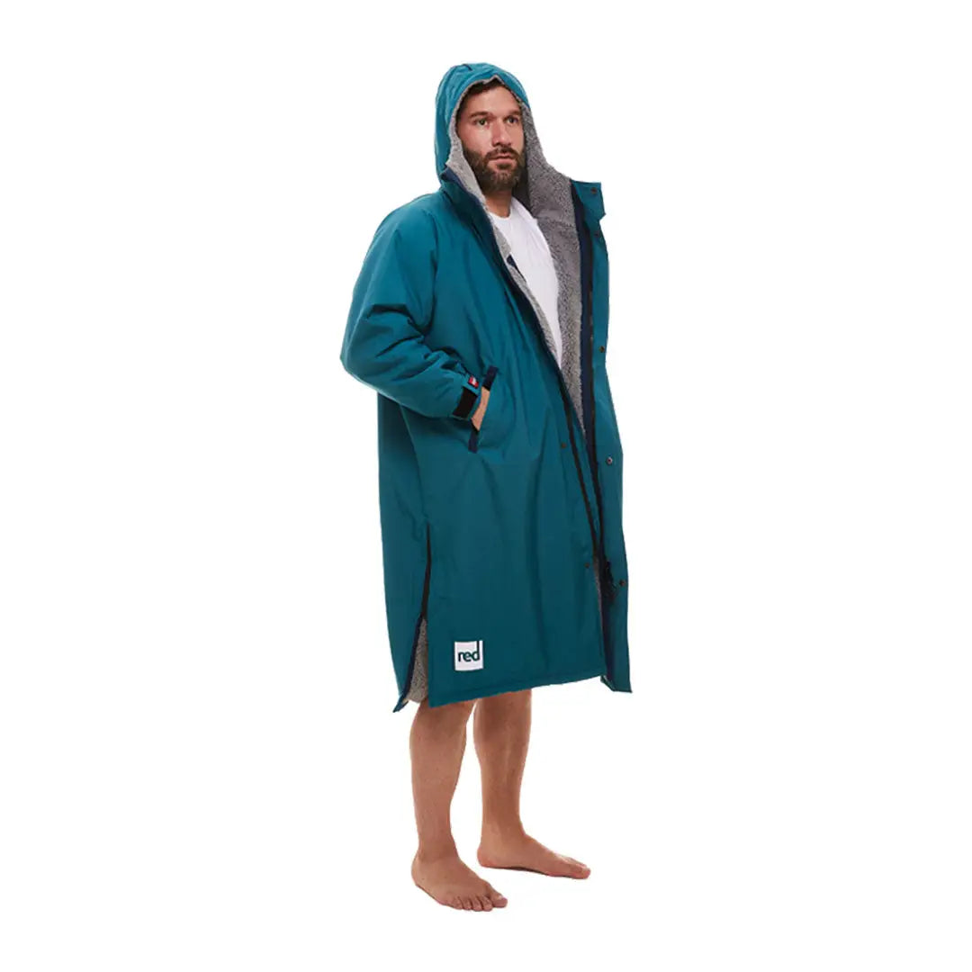 Bearded person in teal hooded towel robe, perfect for outdoor professionals after a swim