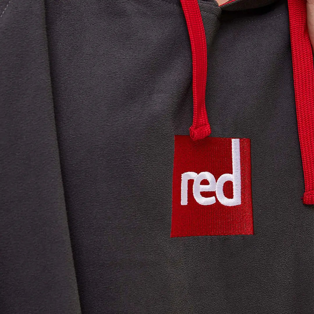 Red tag on a dark gray microfibre changing robe with a red drawstring