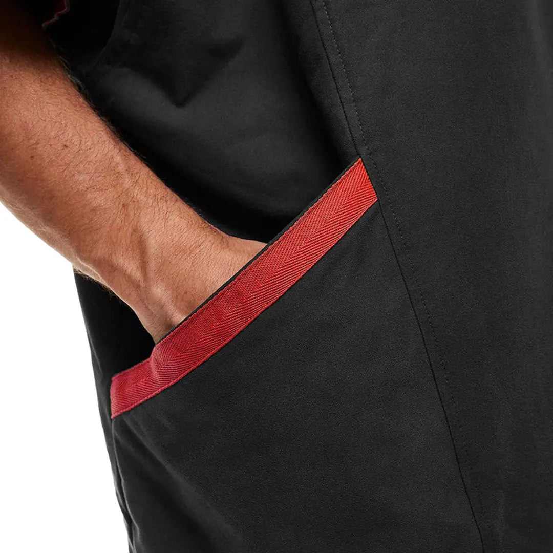 Hand in pocket of Red Quick Dry Microfibre Changing Robe with black fabric trim