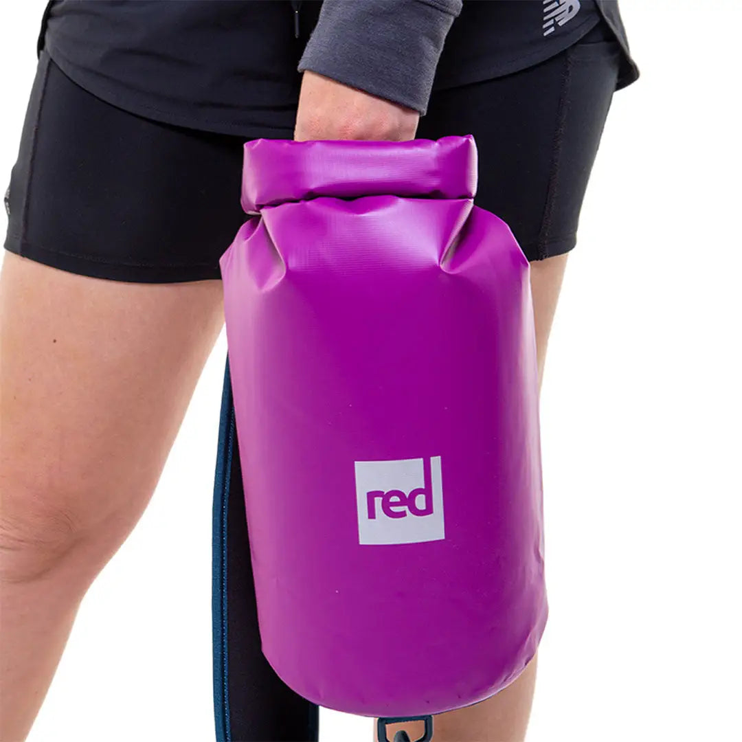 Bright purple 10L dry bag with a red logo, perfect for outdoor adventures