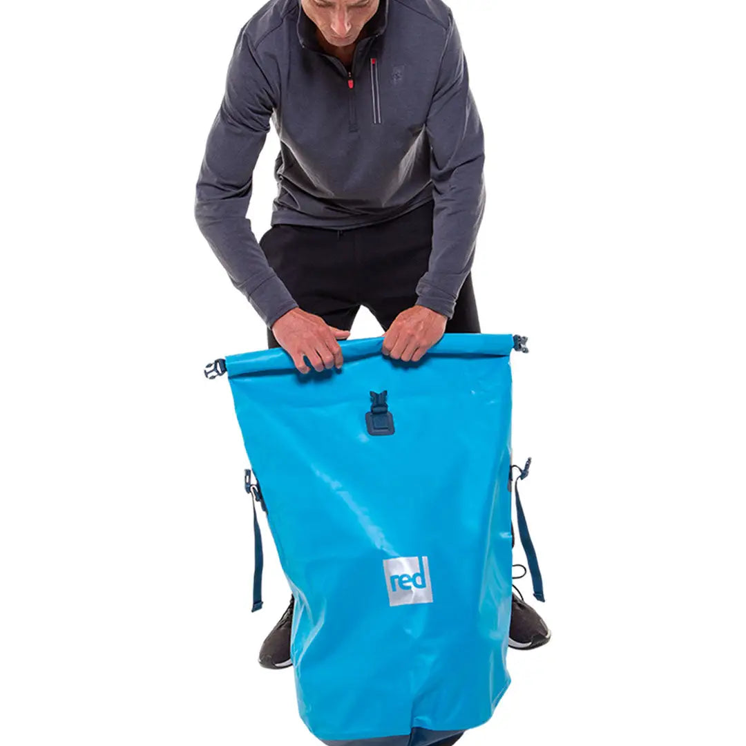 Bright blue waterproof dry bag with roll-top closure for adventure-ready waterproof backpacks