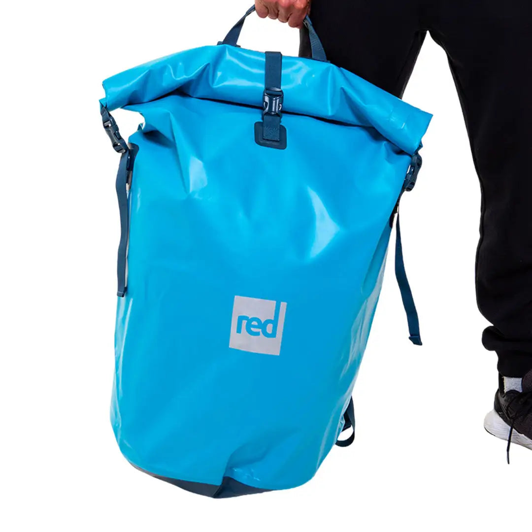 Bright blue waterproof roll-top backpack with red logo, great for country clothing and hunting