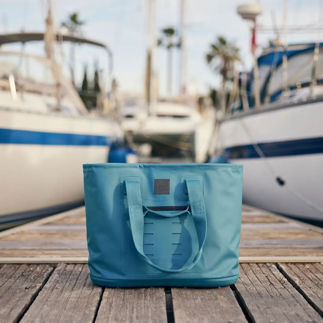 Light blue tote bag on wooden planks, perfect for country clothing and hunting trips