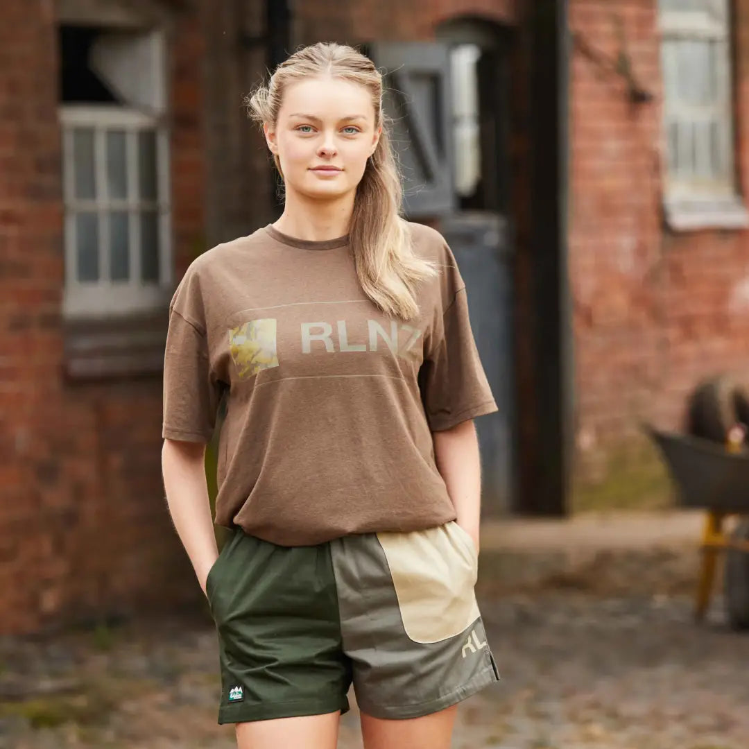 Young woman in brown RLN shirt and green backslider shorts, perfect for country clothing