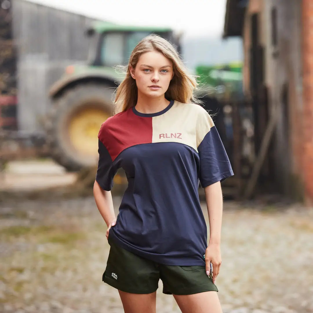 Young woman in a color-block t-shirt and shorts enjoying outdoor country clothing vibes