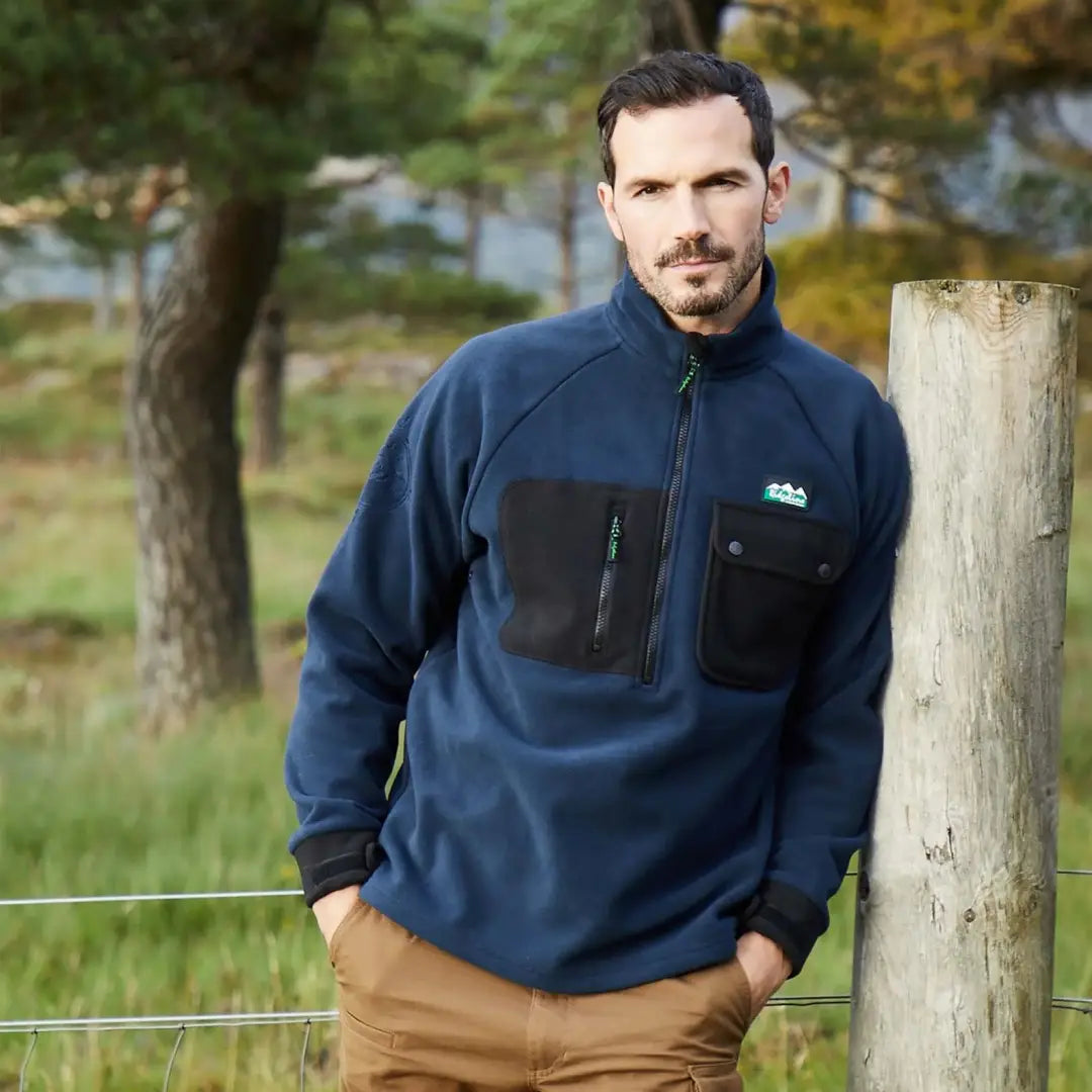 Man in a navy blue durable fleece pullover, the Ridgeline Igloo II Bush Shirt