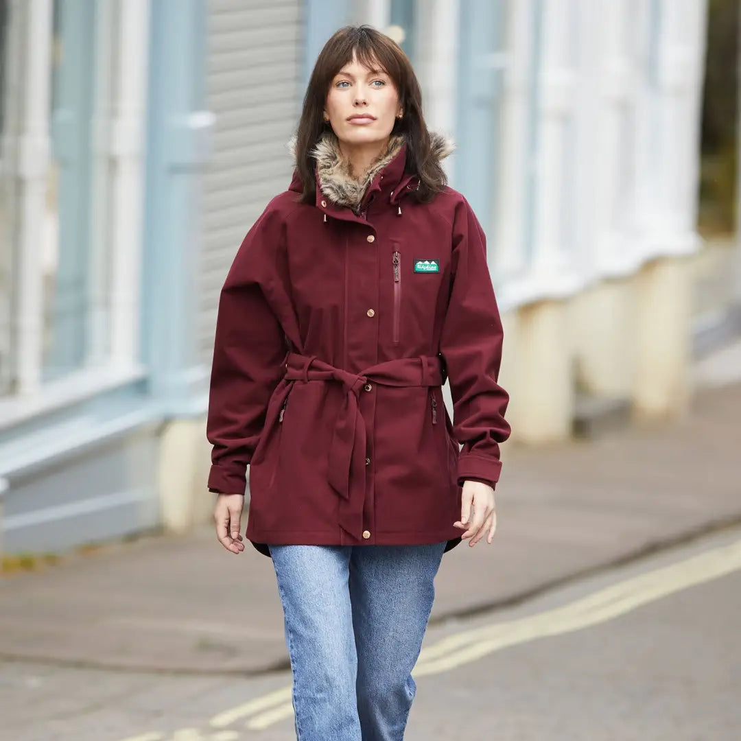 Burgundy belted Monsoon Nordic Jacket with fur-lined collar styled over jeans