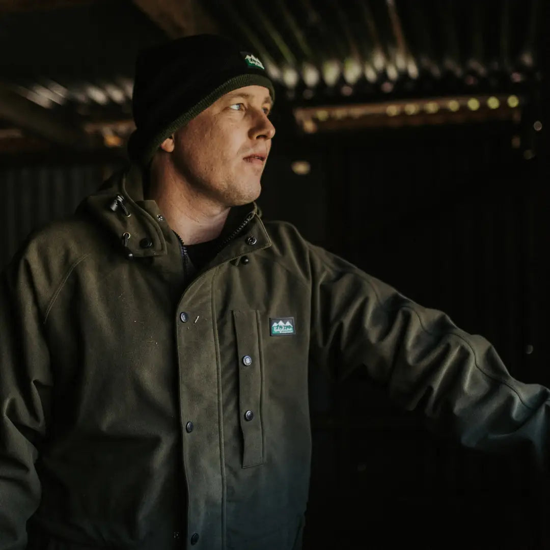 Person in a dark green Ridgeline Monsoon Classic Waterproof Jacket and black beanie