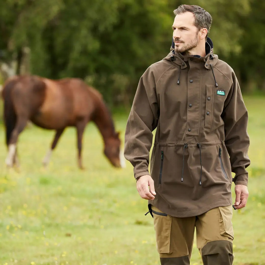 Man in a Ridgeline Monsoon Classic Waterproof Smock standing by a horse in a field