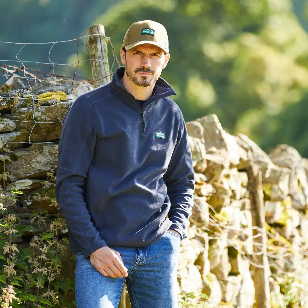 Man in a navy blue sweatshirt and cap enjoying the outdoors with Ridgeline Narvik Fleece