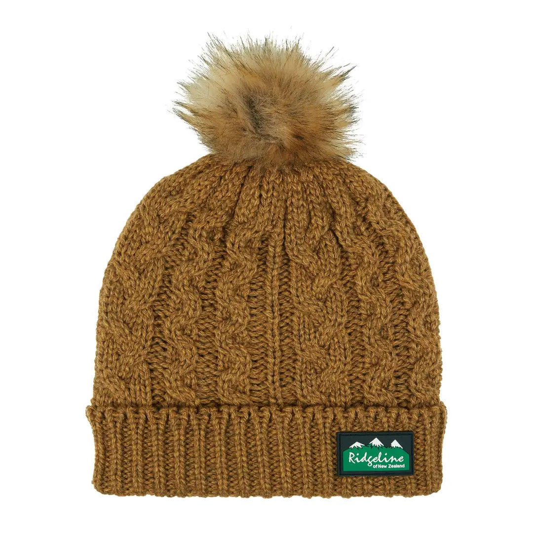 Knitted brown winter hat with furry pom-pom, a stylish Nordic Fleck Bobble look