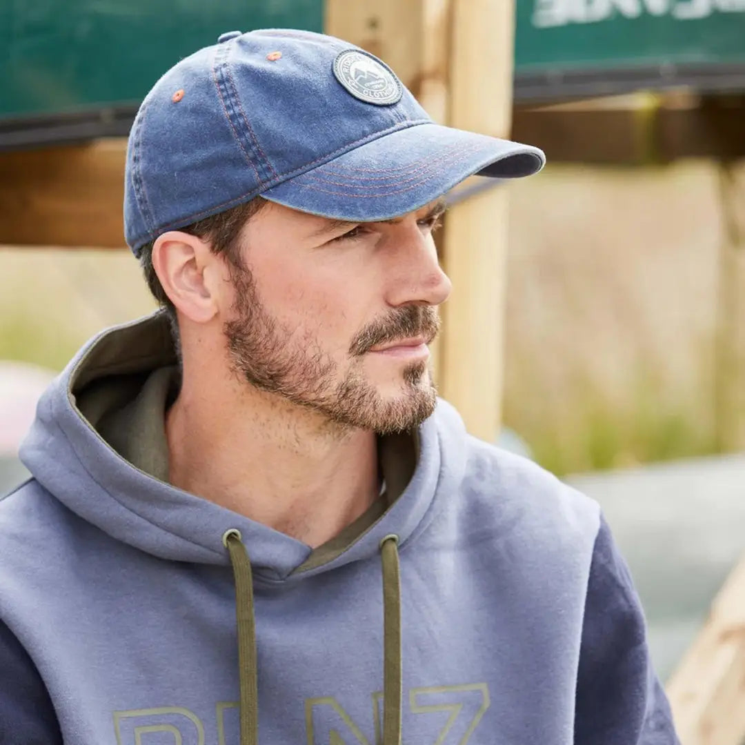 Bearded man in gray hoodie rocks a Blue Original Truckie Cap with logo