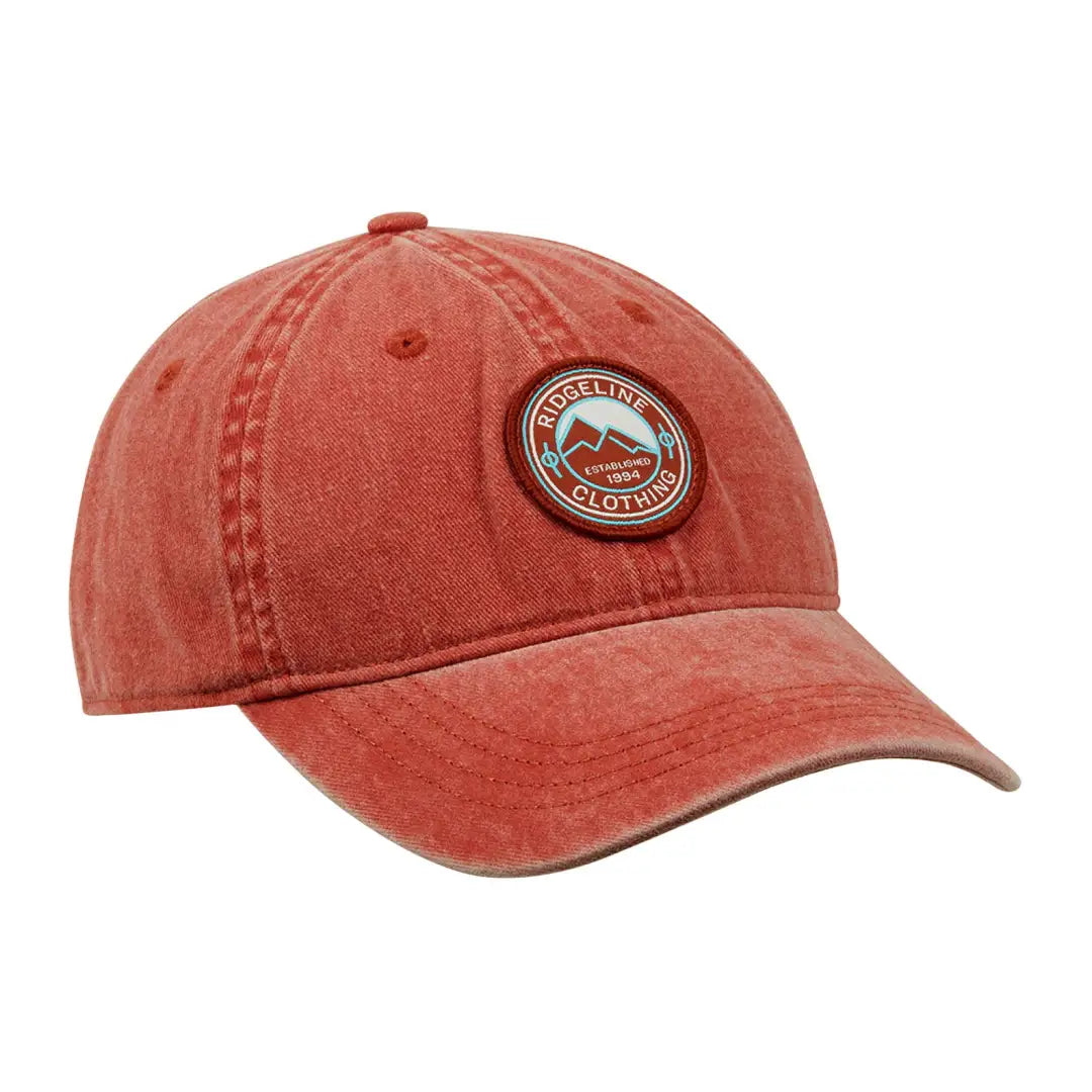 Red baseball cap featuring a circular logo patch from the Ridgeline Original Truckie Cap