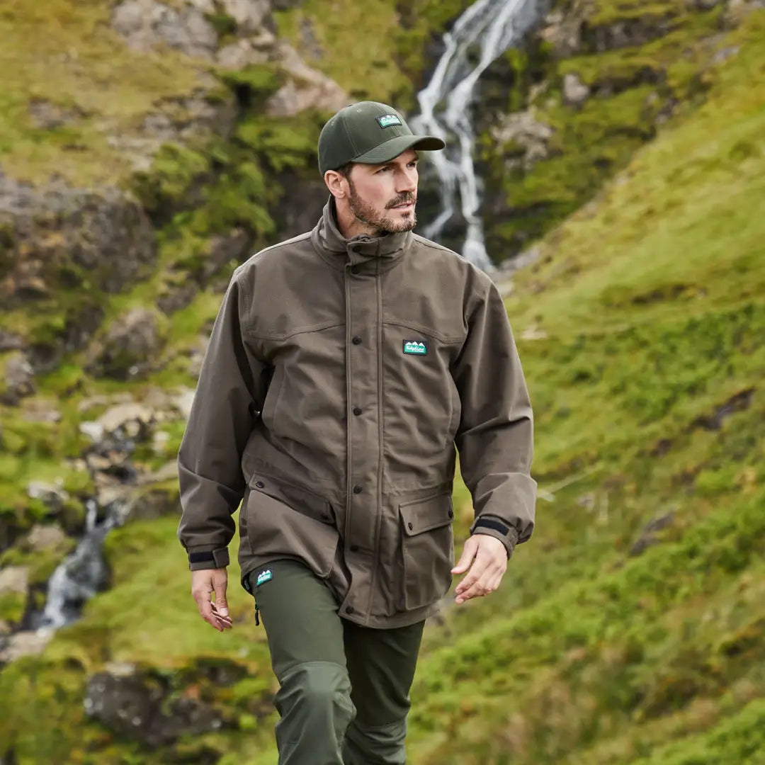 Man in Ridgeline Torrent III Jacket hiking through a stunning mountainous landscape