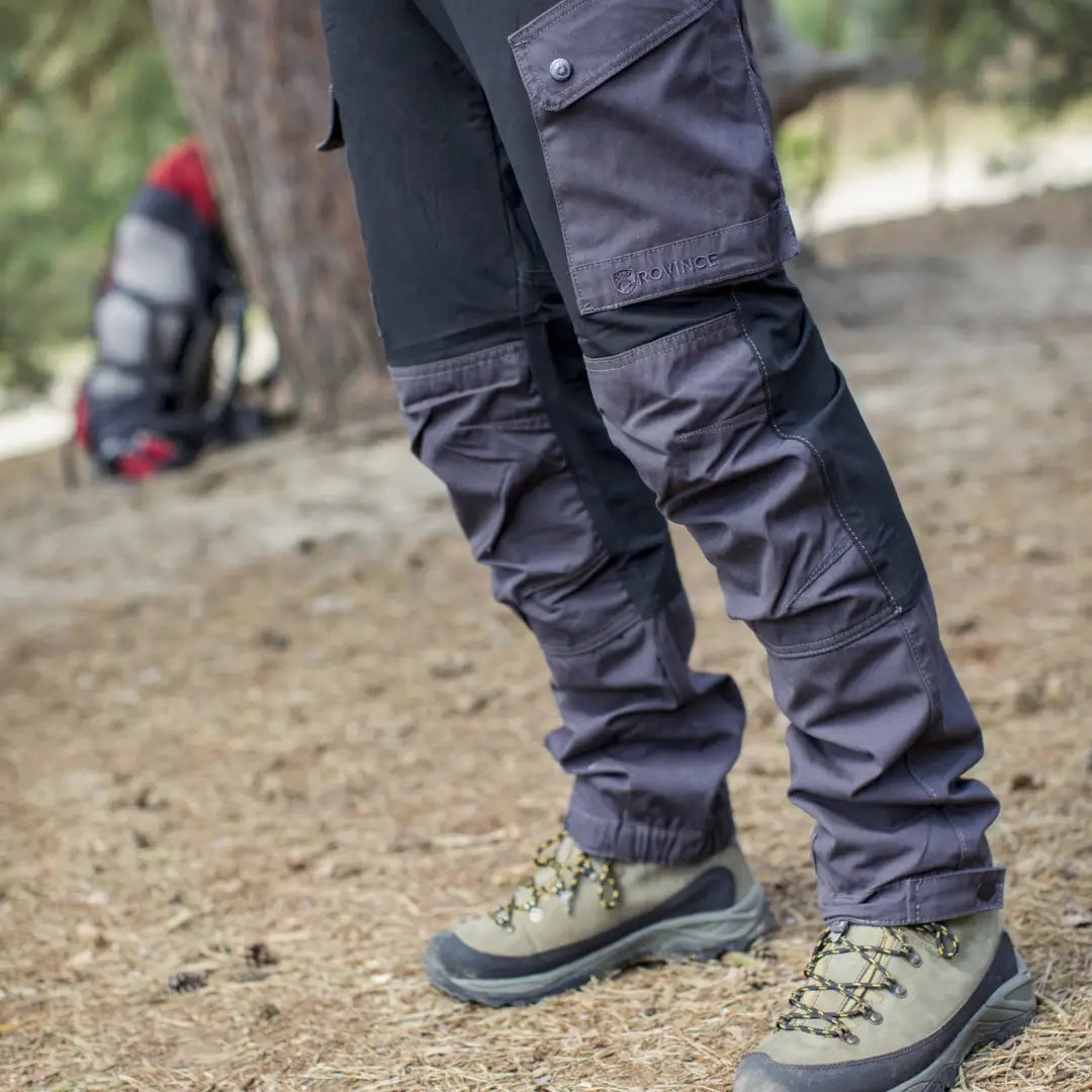 Hiking boots and Rovince Flexline Trousers with metal shoelace hook on a trail