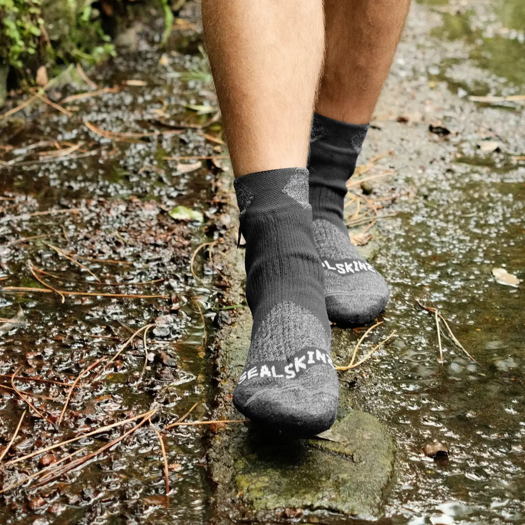 Gray Raynham Waterproof Socks splashing through shallow water for ultimate protection