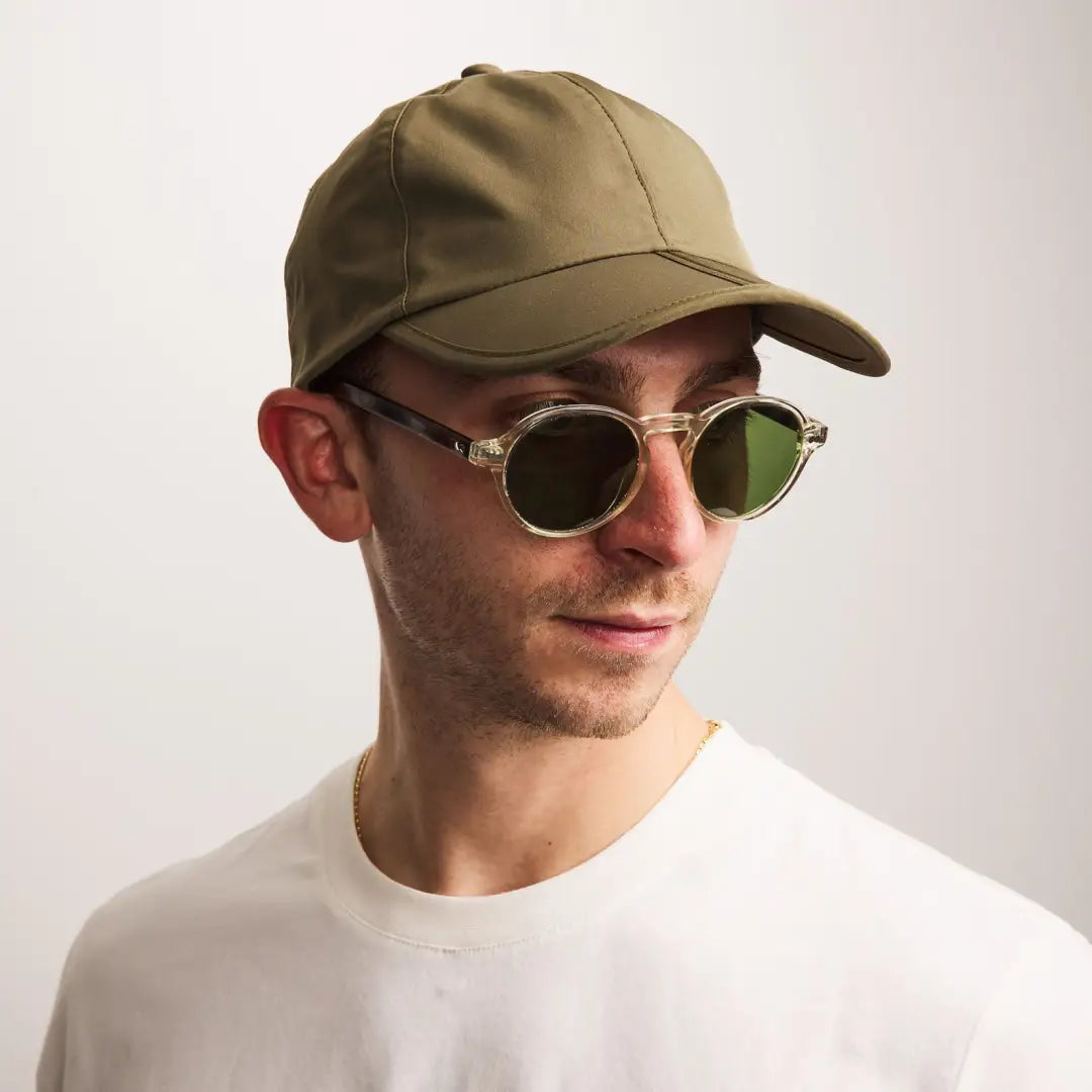 Man in khaki baseball cap and green sunglasses wearing Sealskinz Salle Cap