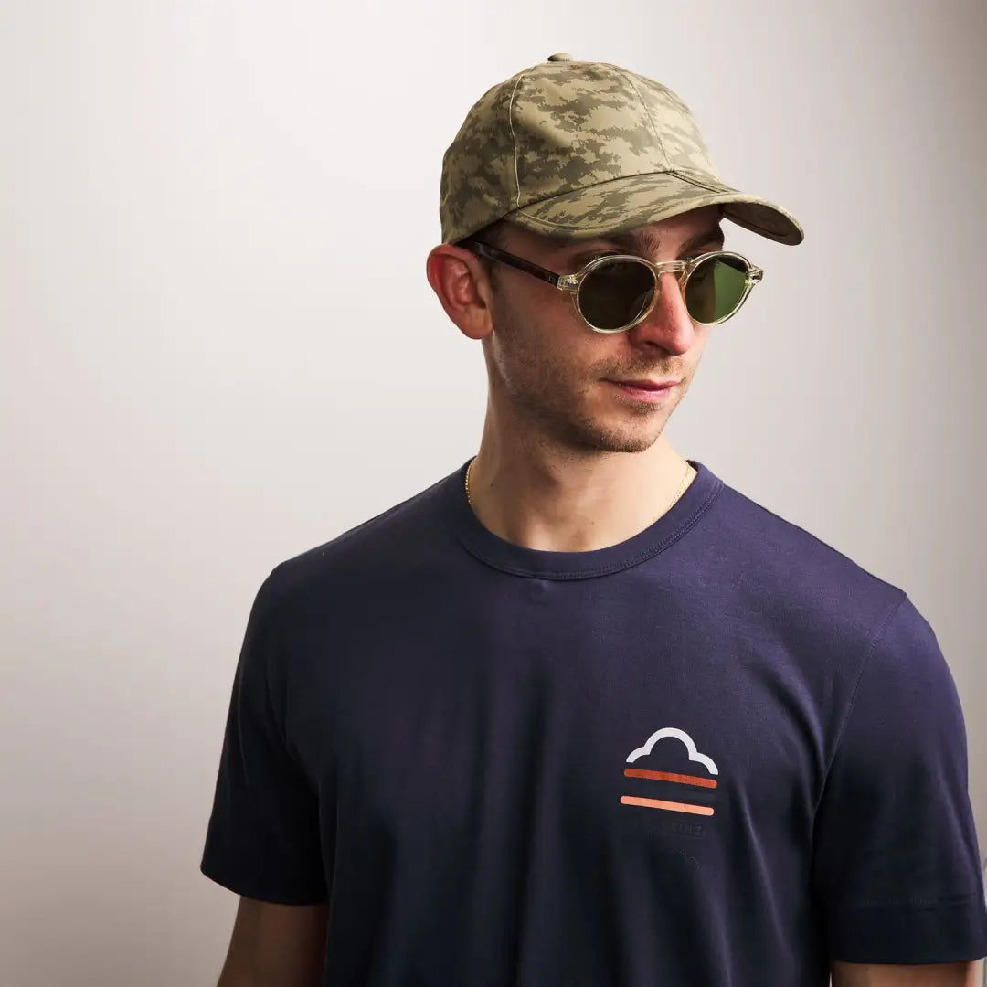 Young man in navy t-shirt and camouflage cap, perfect for country clothing and hunting