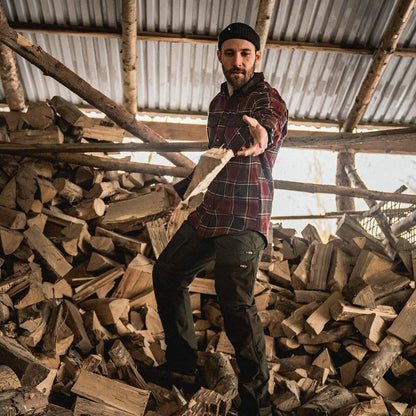 Bearded man in plaid with Seeland Glen Flannel Shirt holding firewood