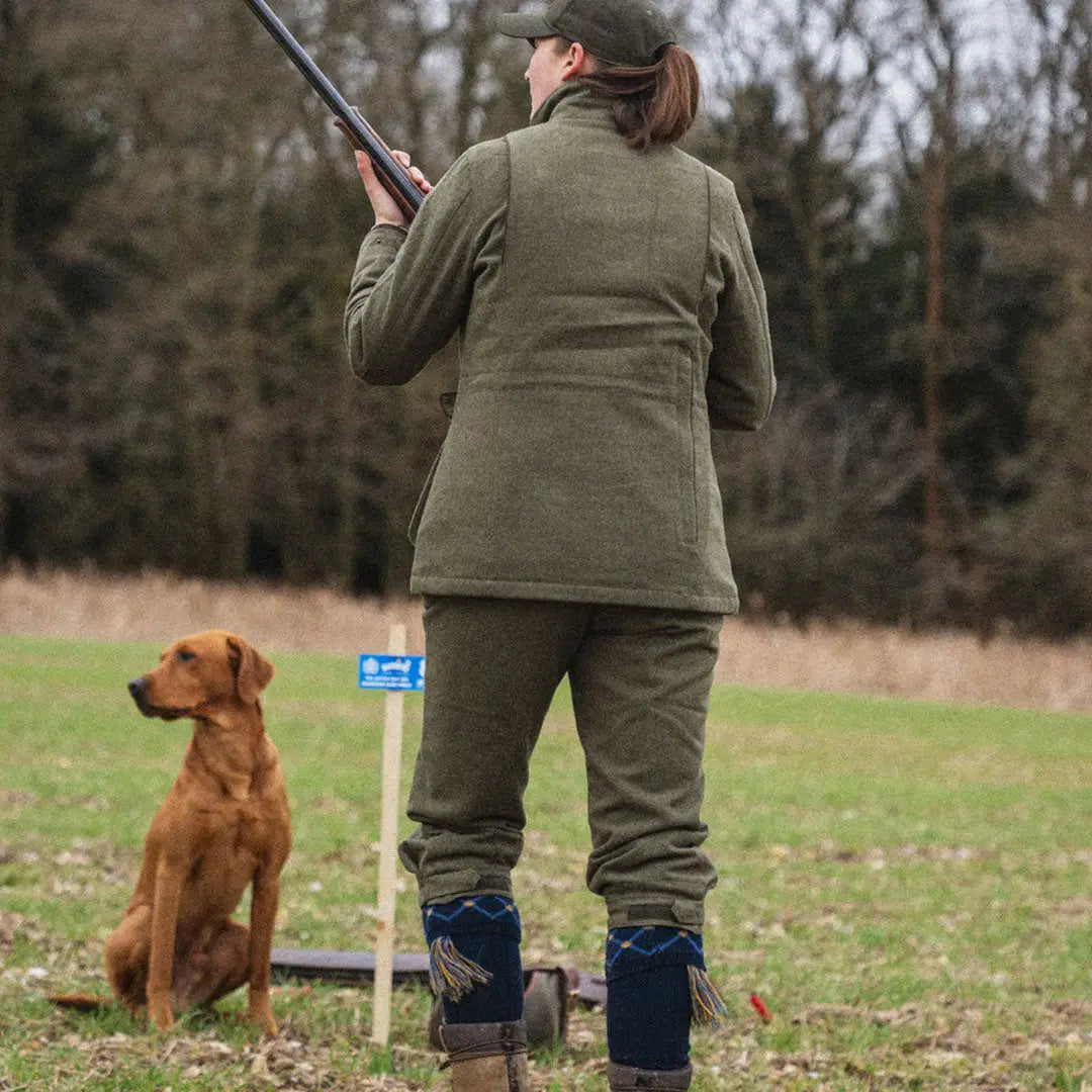 Dog next to a person with a shotgun wearing the Seeland Hillside Harriet Jacket