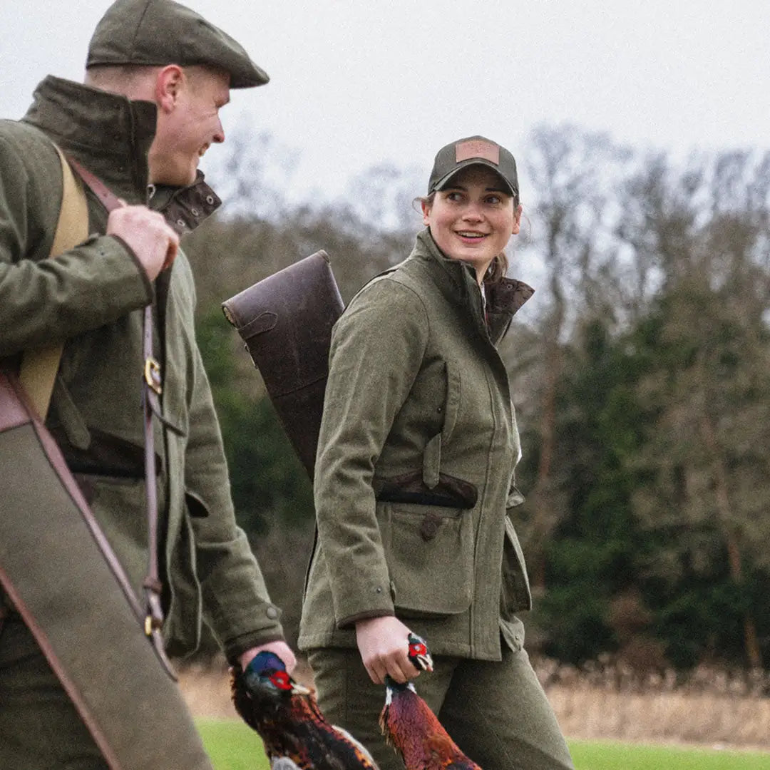 Two hunters in Seeland Hillside Harriet jackets enjoying the outdoors with shotguns