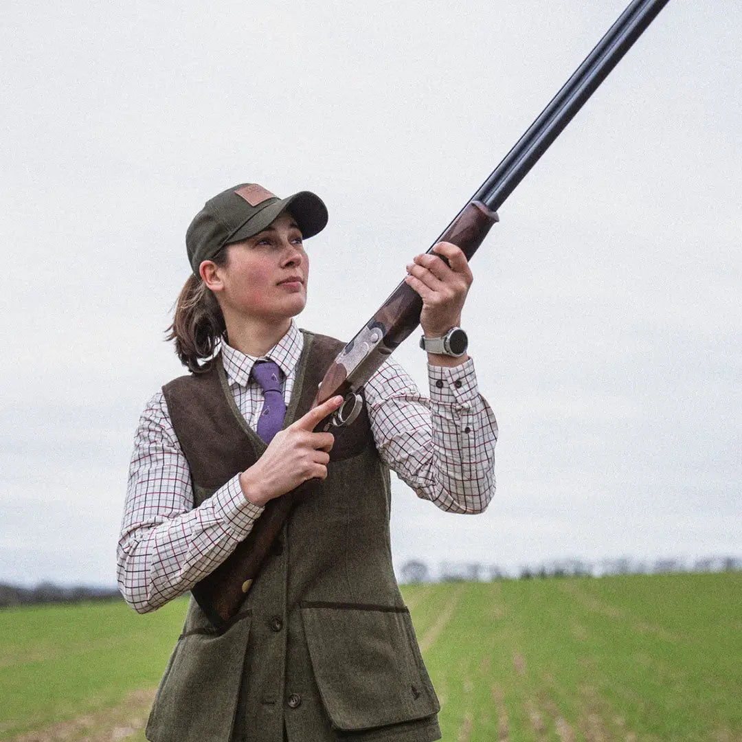 Person in hunting attire holding a shotgun wearing Seeland Hillside Harriet Waistcoat